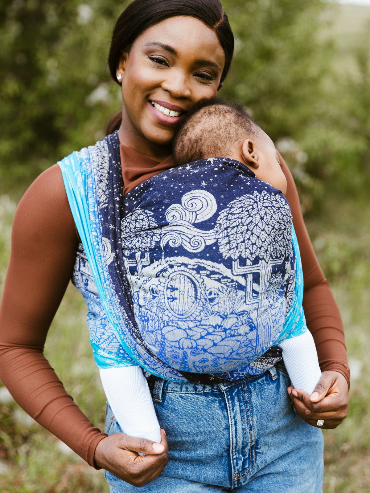 Oscha Hobbiton design in blues on a baby wrap carrier