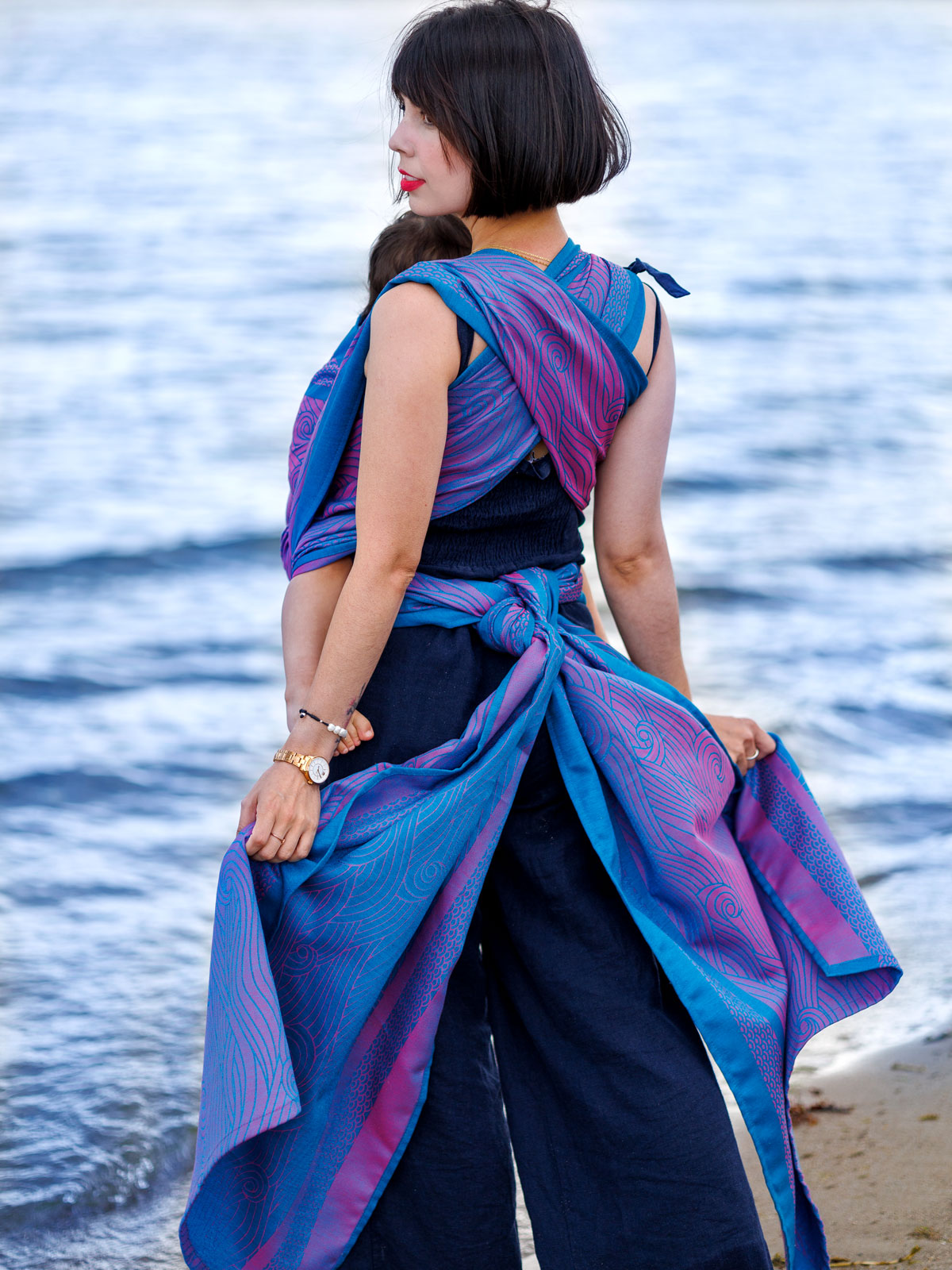 Kasumi Glint baby wrap in front of ocean