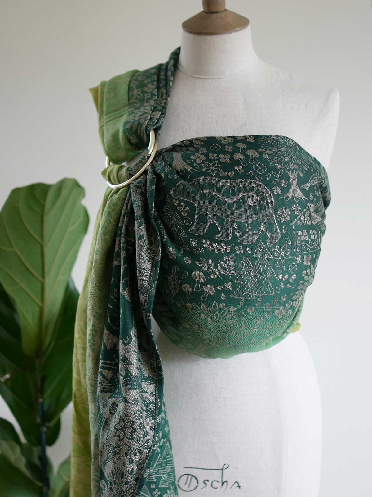 Green ring sling with animal folk design on a mannequin