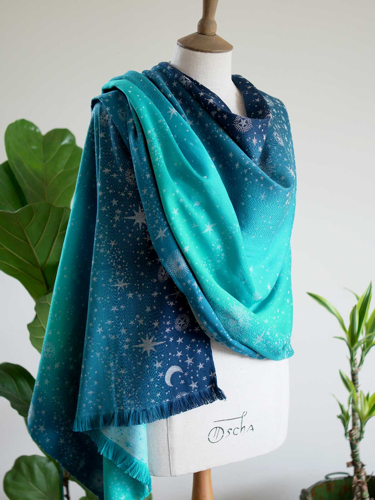 Blue and teal scarf with starry pattern draped over a mannequin