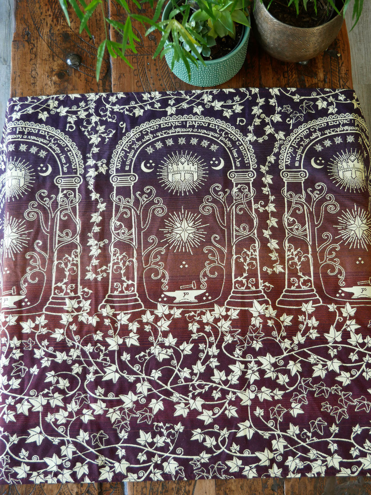 Woven fabric with in autumnal colours on a wooden surface