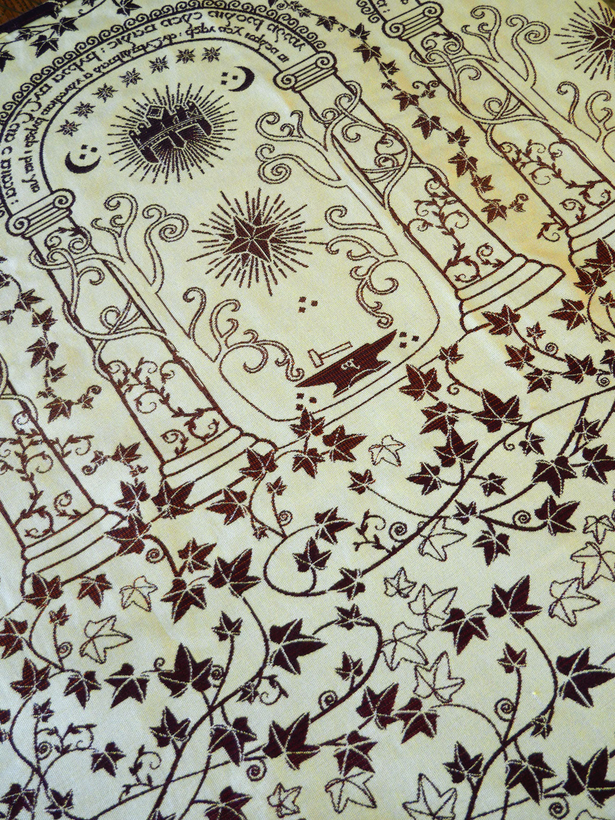 Decorative design with intricate patterns and symbols on a beige background