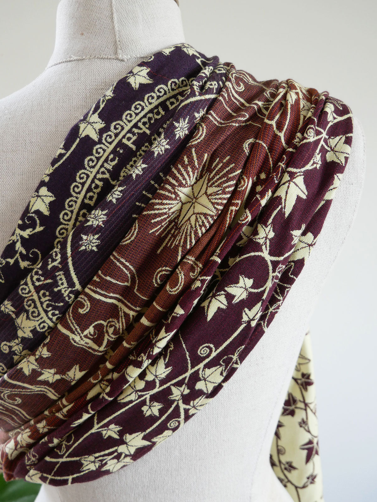 Patterned fabric draped over a mannequin on a white background