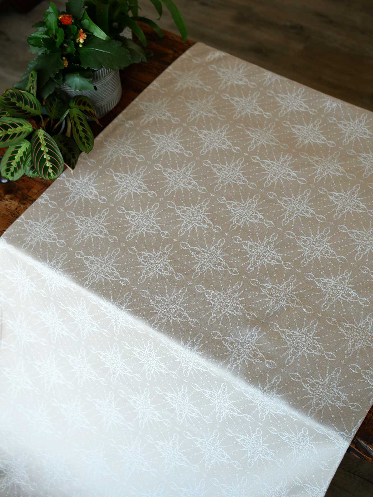 Fabric with intricate pattern on a wooden chest