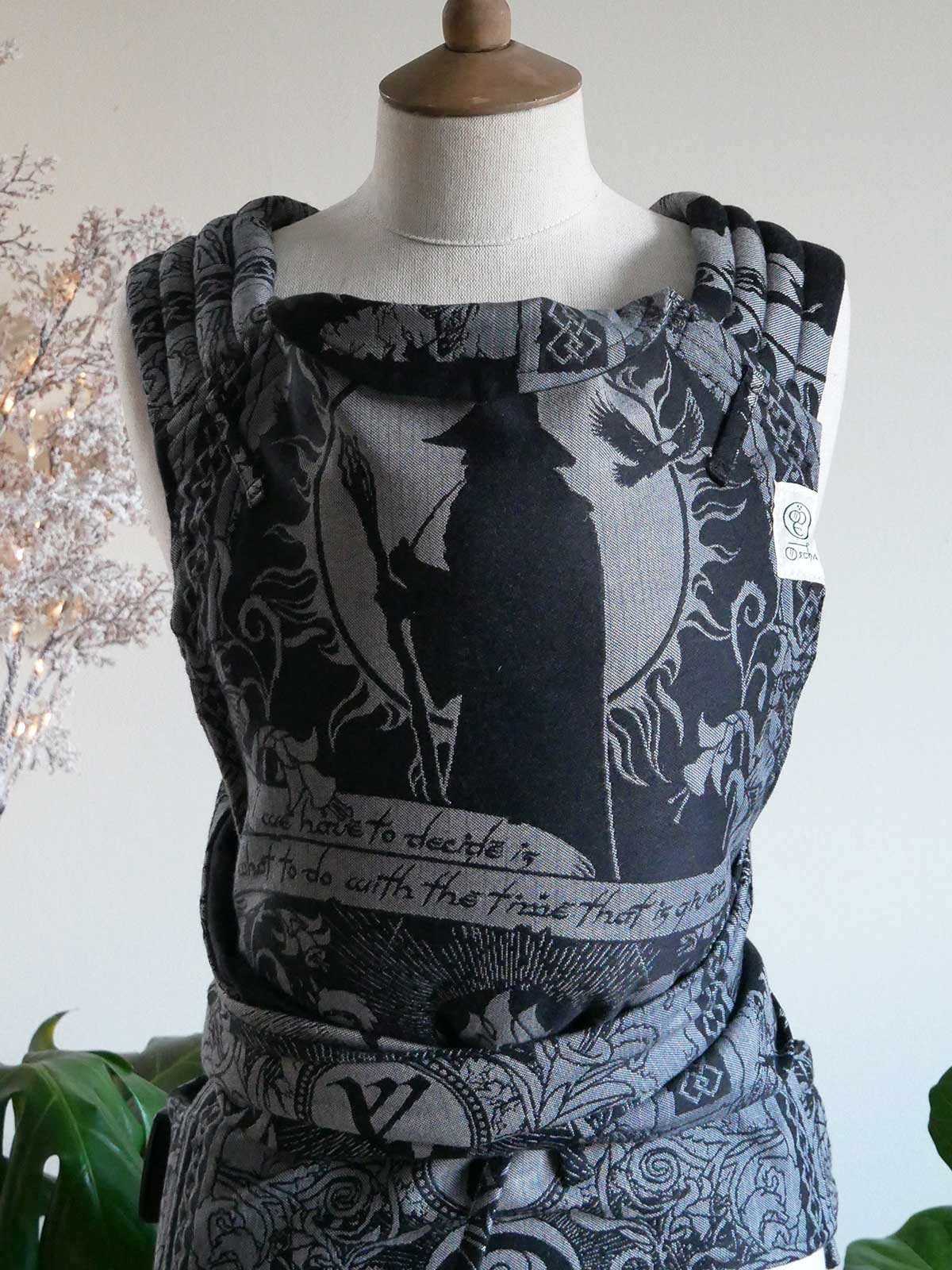 Black and silver patterned baby carrier Gandalf the Grey Cairis Baby Carrier on a mannequin against a neutral background