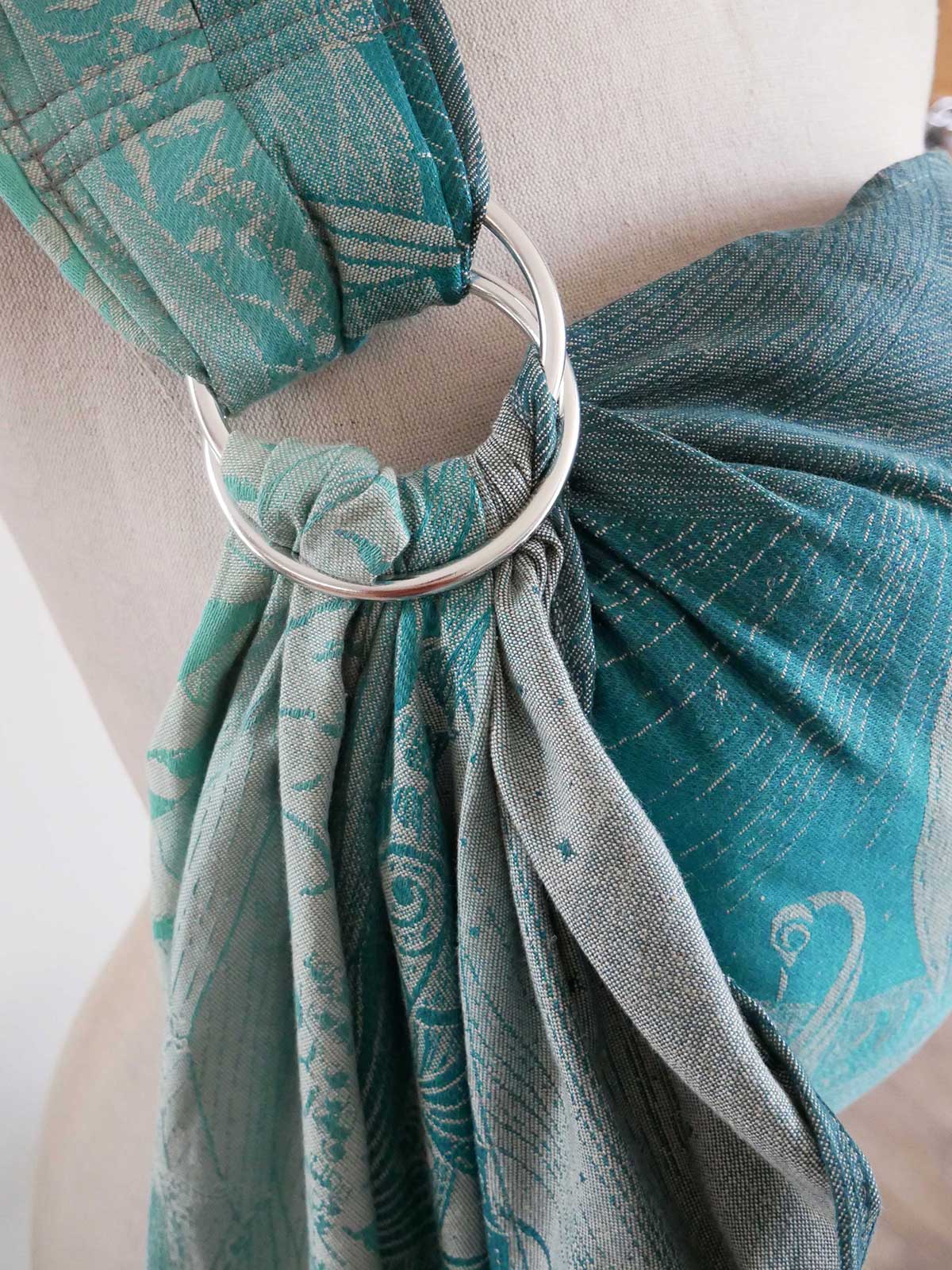 Teal sling with a silver ring on a mannequin