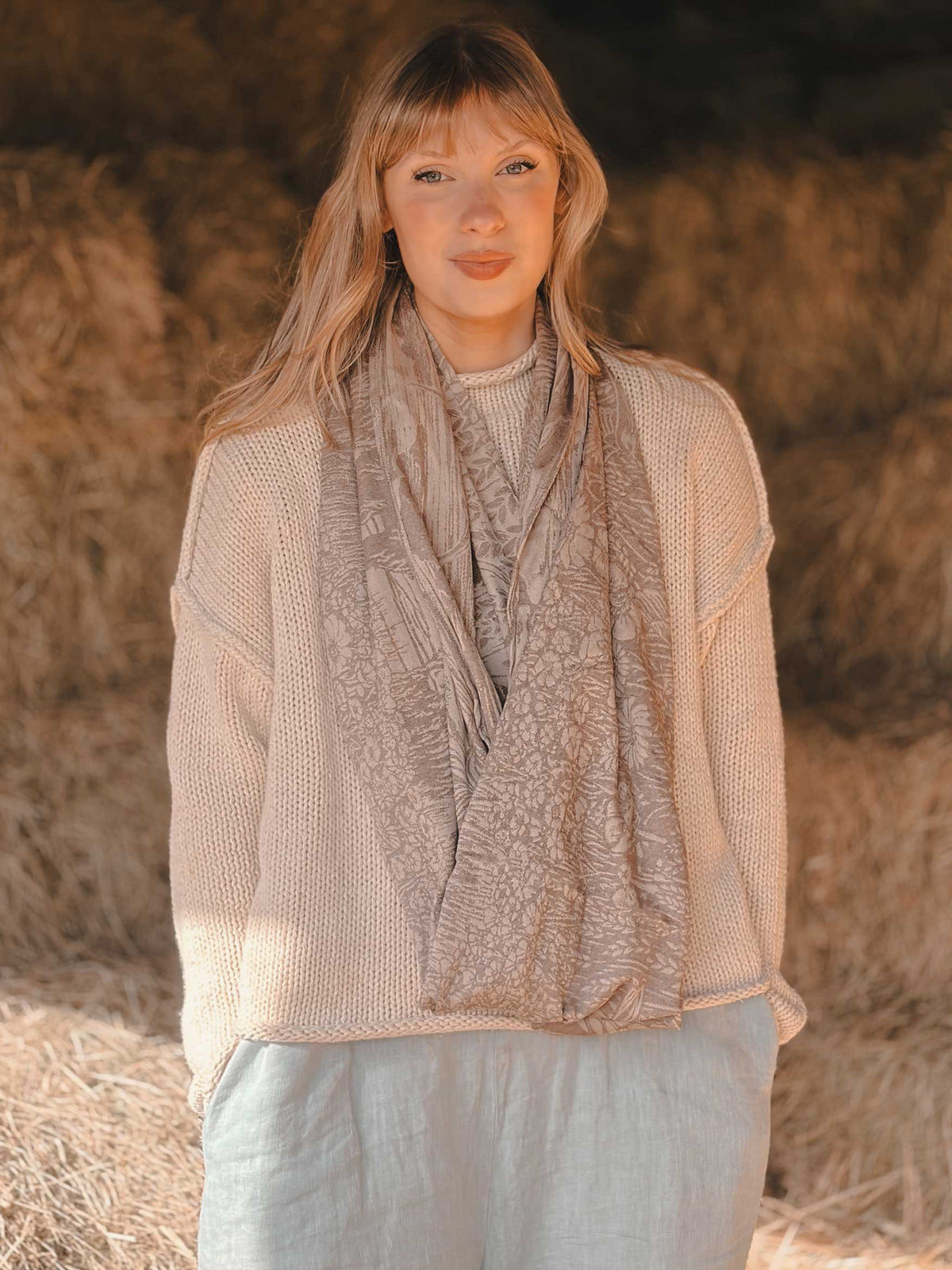 Woman wearing an oatmeal coloured infinity loop.