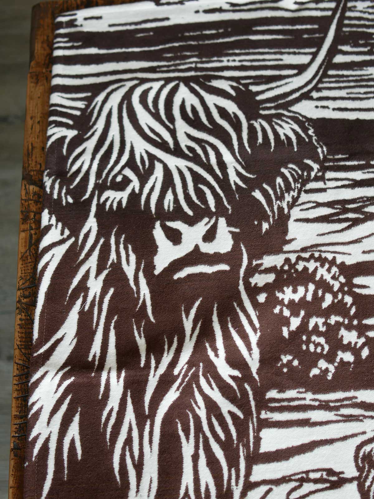Close up of highland cow on a brown fabric