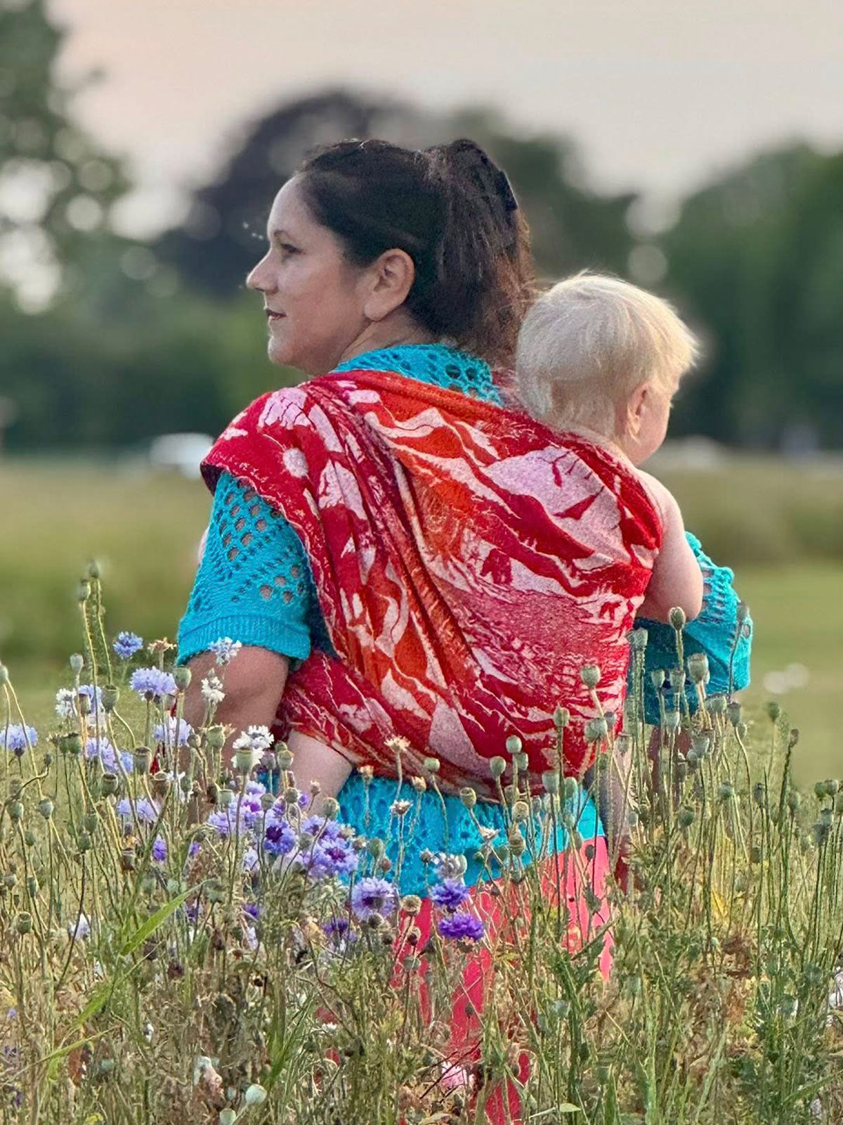 Lord of the Rings baby wrap worn in back carry.