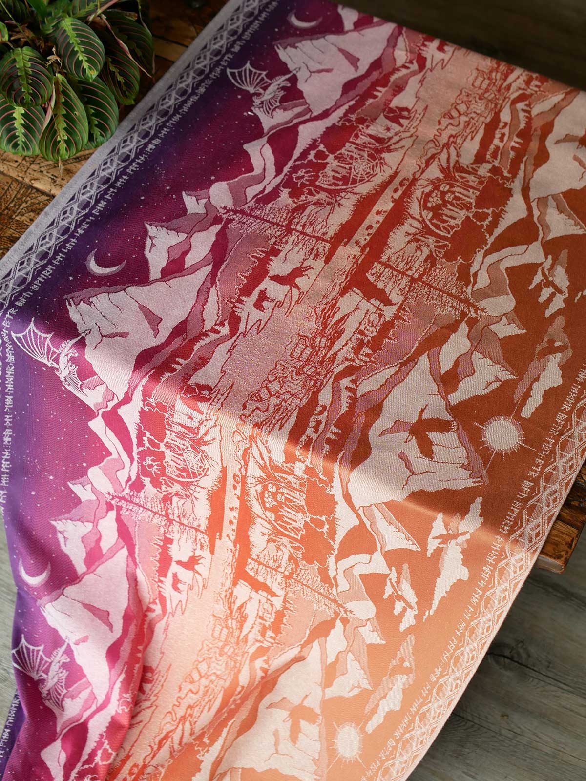 Baby wrap laid out on a table showing the full Hobbit Quest design.