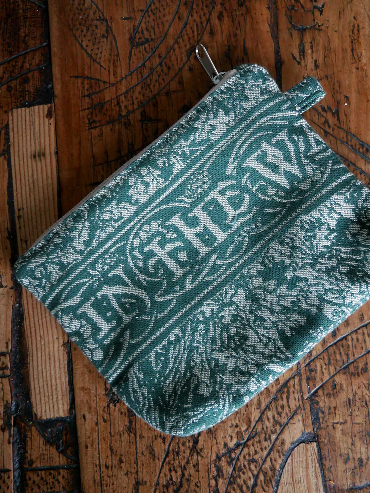 Green patterned zip pouch.