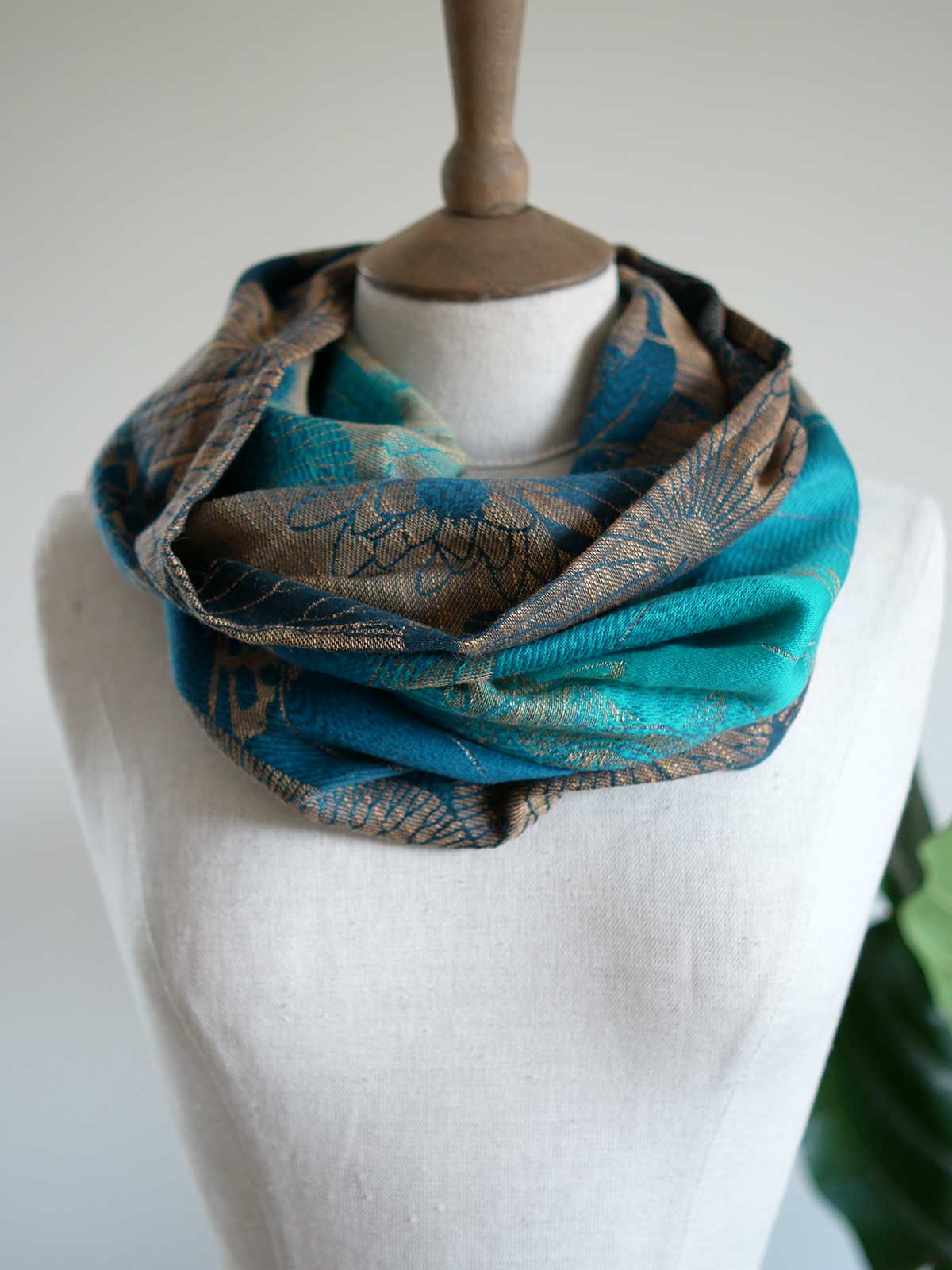 Front view of Koi Moire cowl in teal