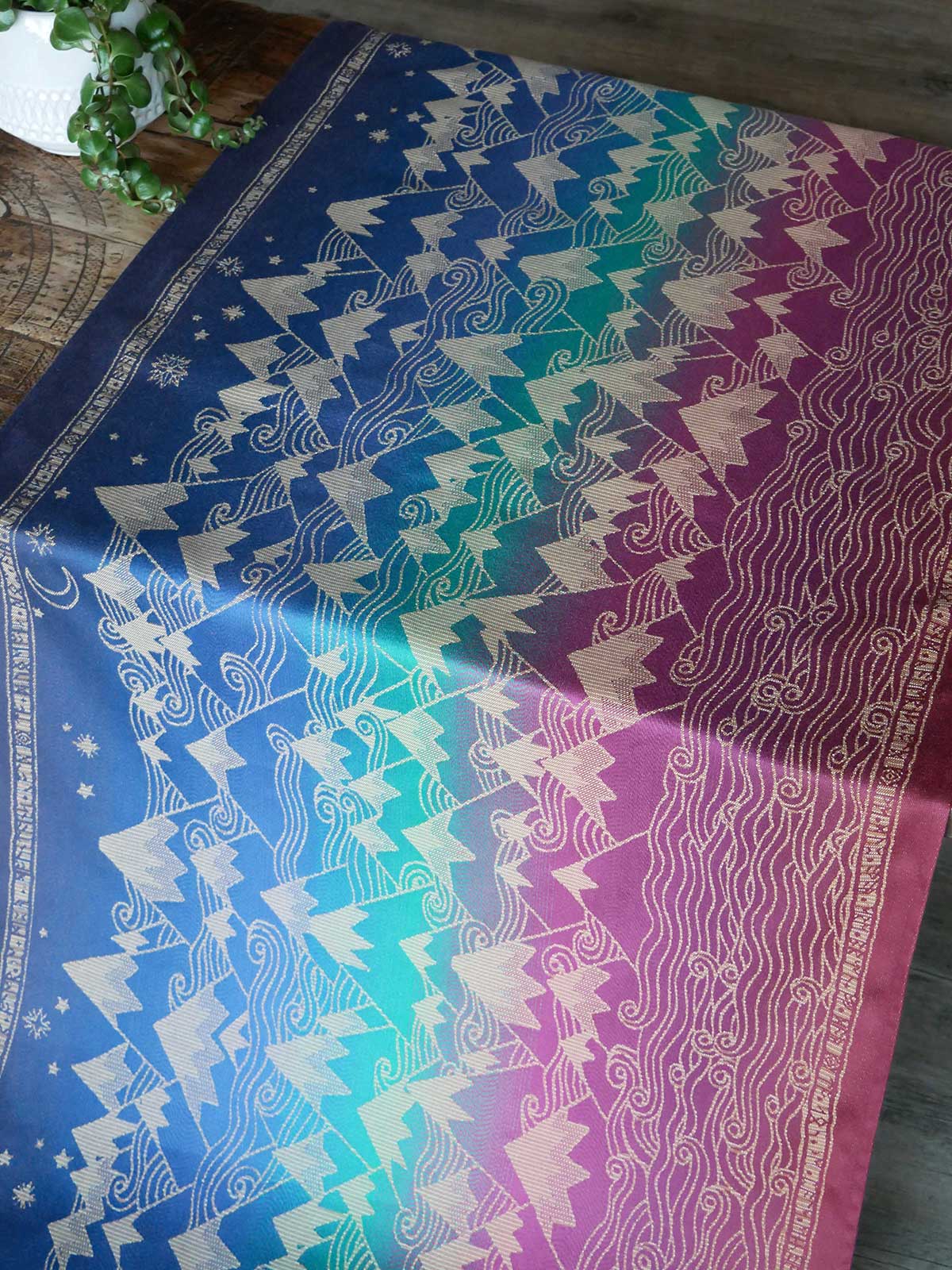 Colorful fabric with mountain patternon a wooden surface