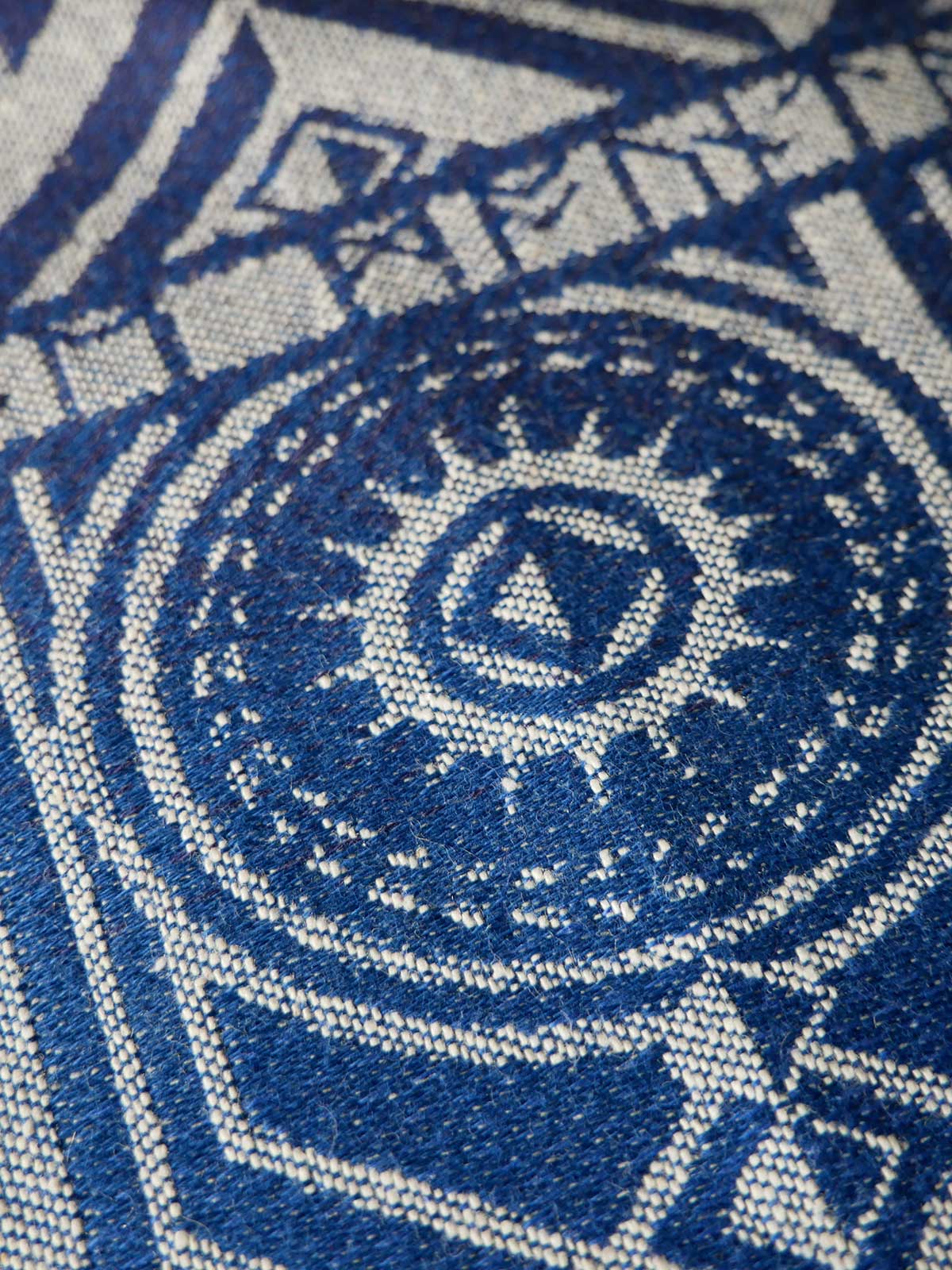 Close up of a blue and ecru pattered fabric