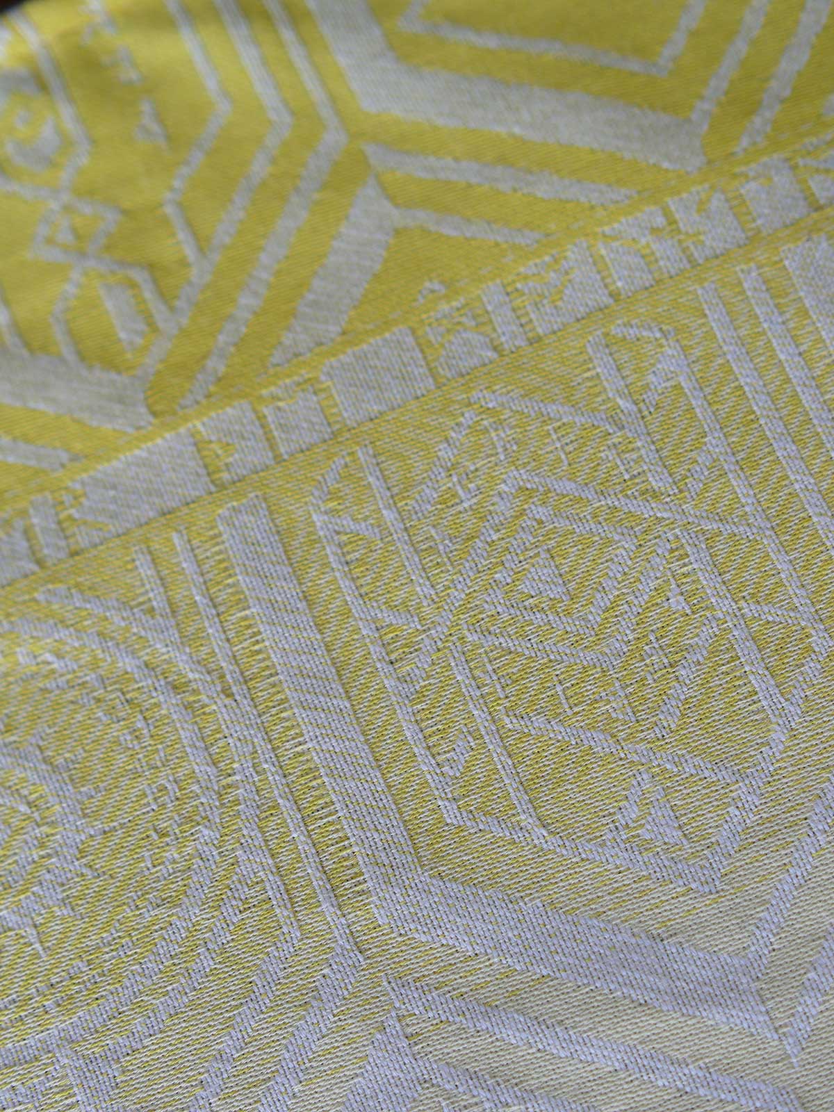 Close up of a yellow fabric with geometric pattern