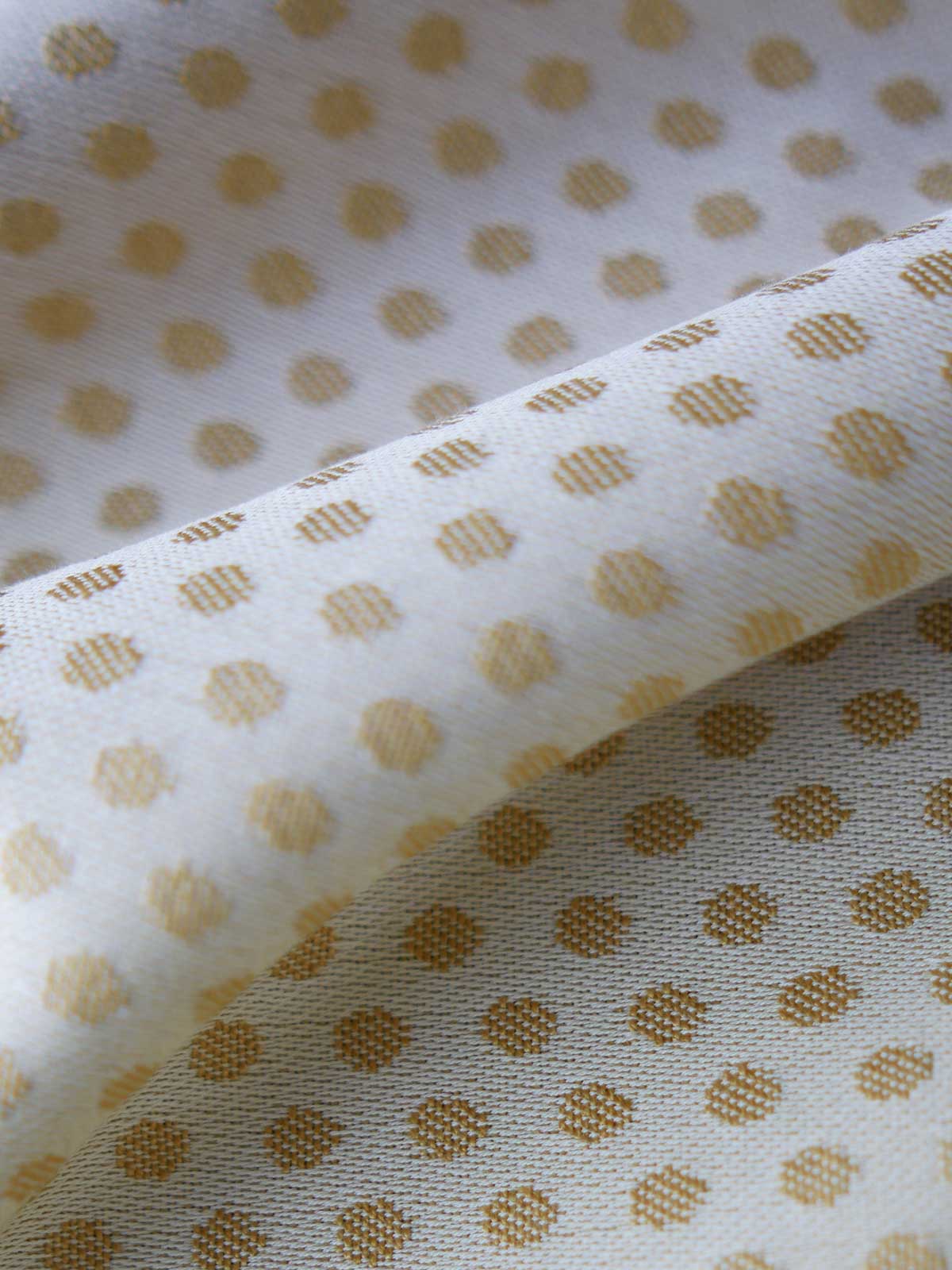 Reverse of lemon and gold fabric with dots.