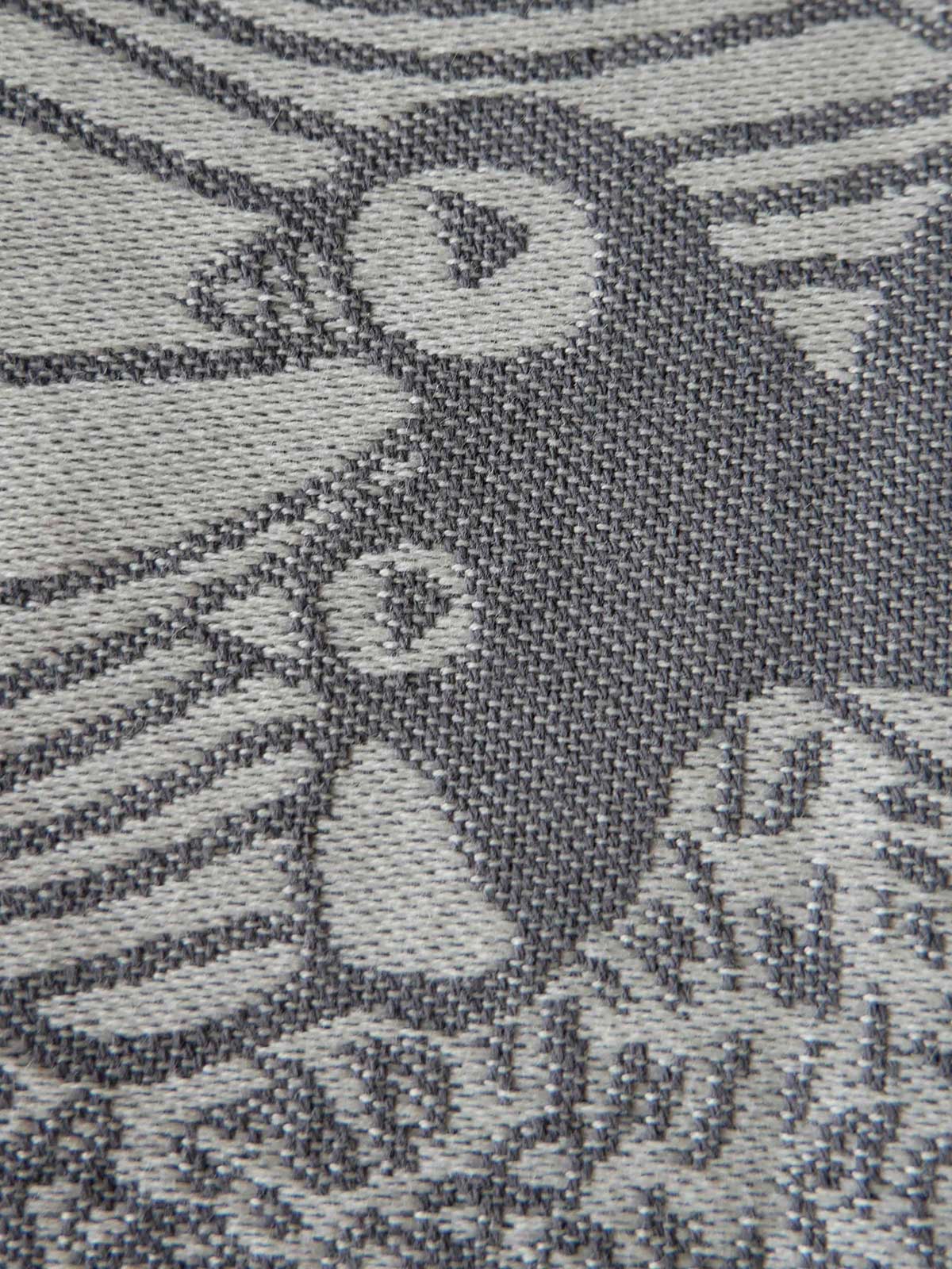 Close-up of a textured fabric with a puffin pattern