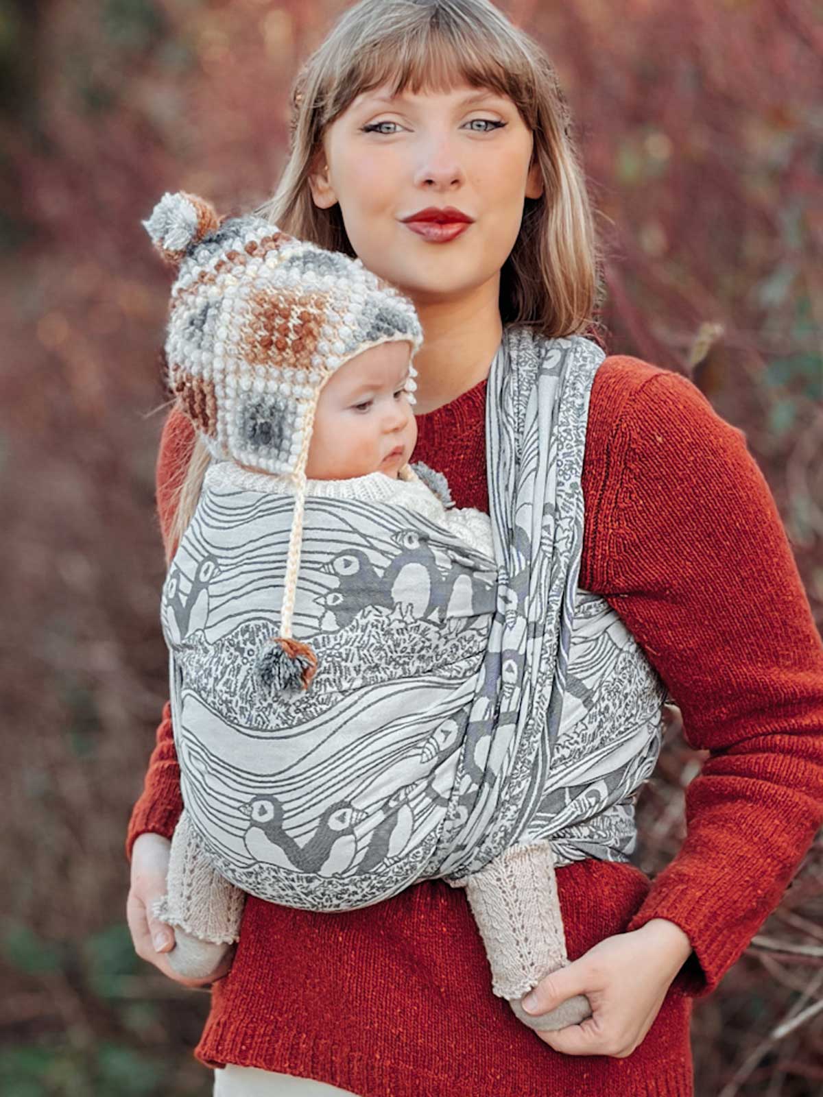 Woman wearing a baby in Puffins Muckle Flugga Baby Wrap outdoors