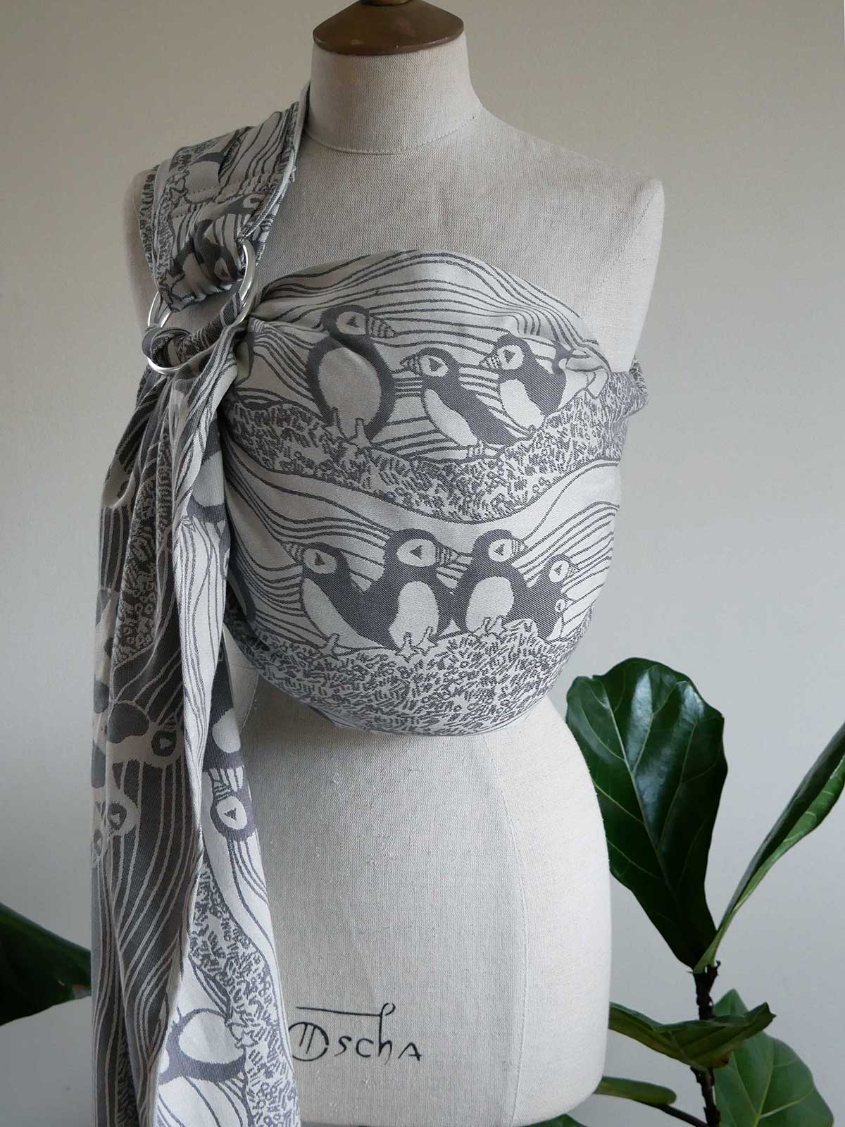 Mannequin wearing a grey and white Puffins Muckle Flugga Ring Sling.