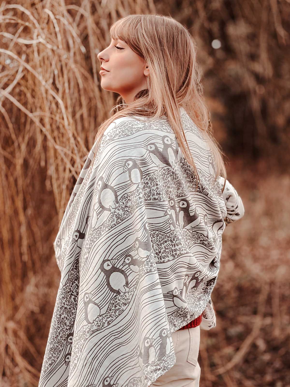 Woman wearing a patterned shawl in a natural setting