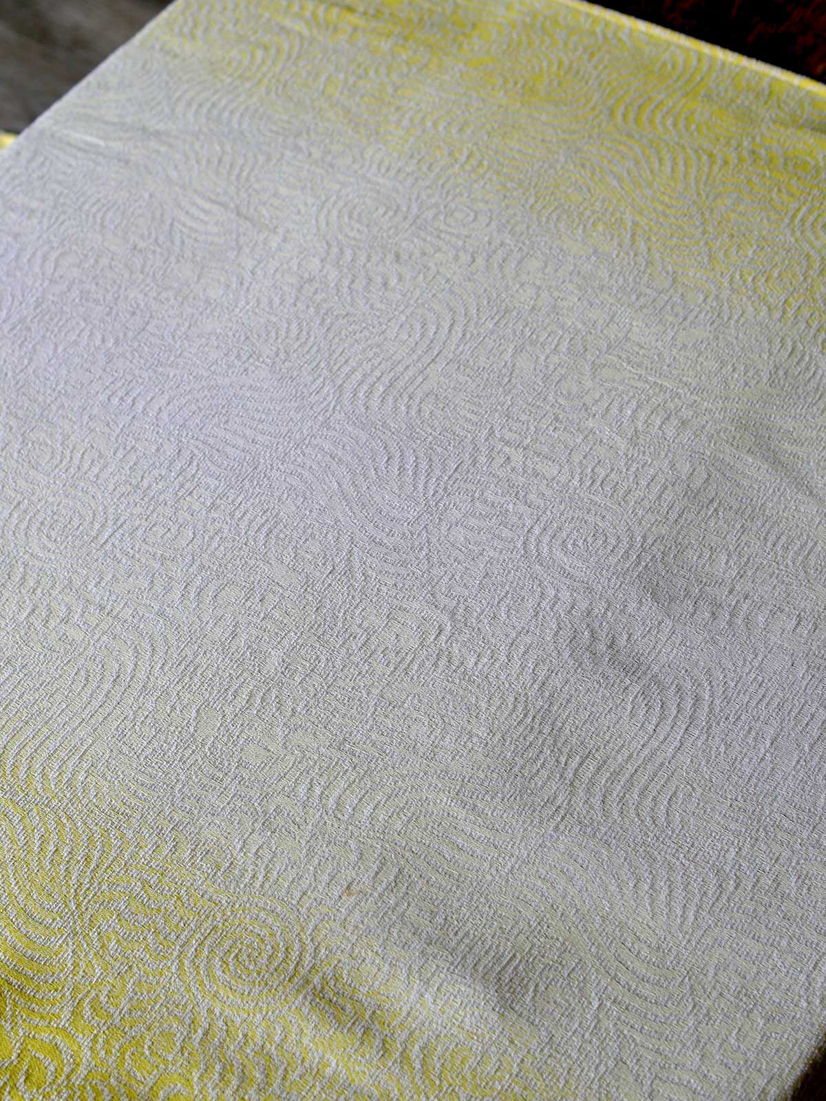 Yellow and white woven fabric with a swirling pattern