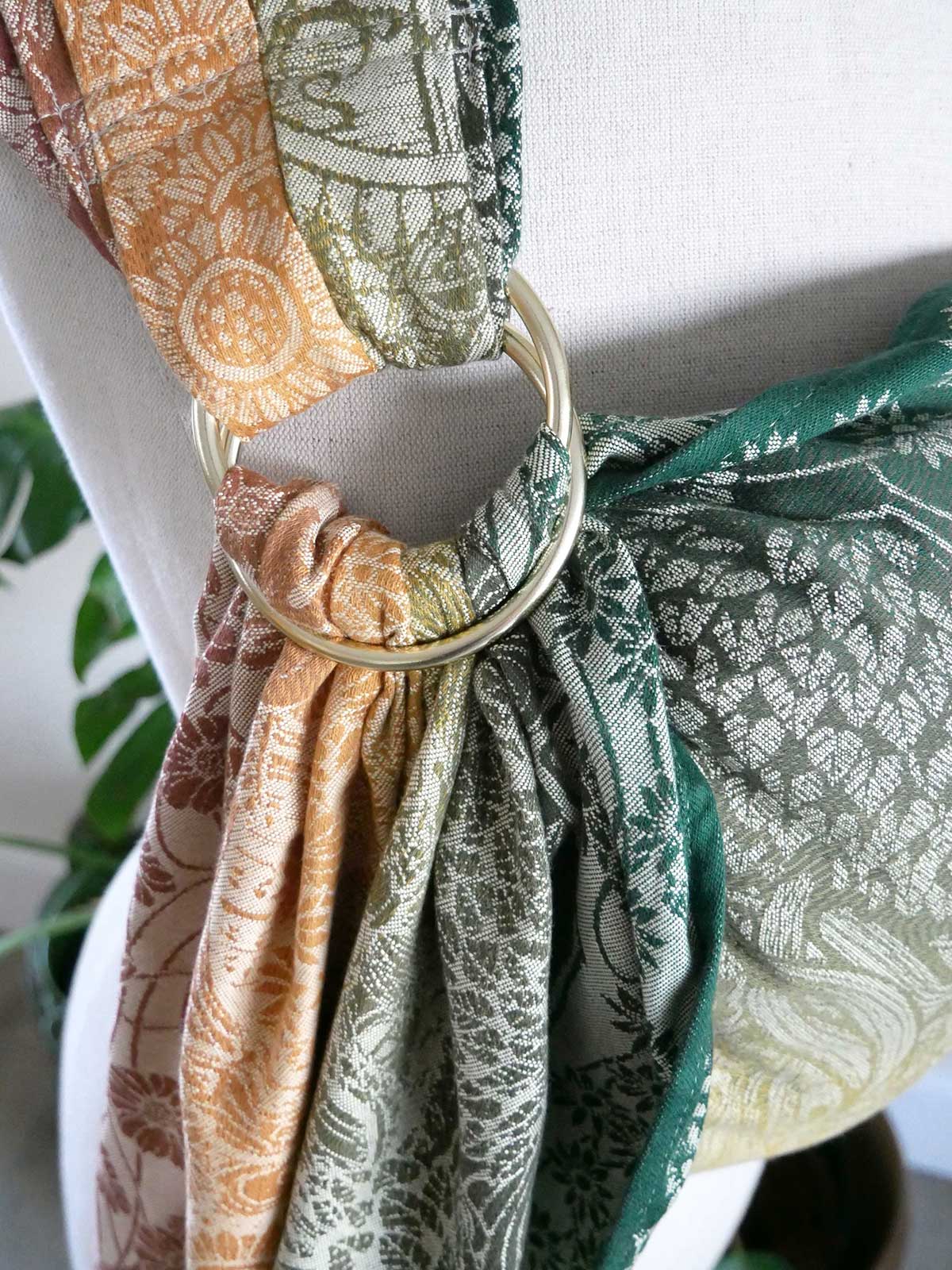 Close-up of Shire Harvest Light Ring Sling, featuring green, brown, and beige patterns.