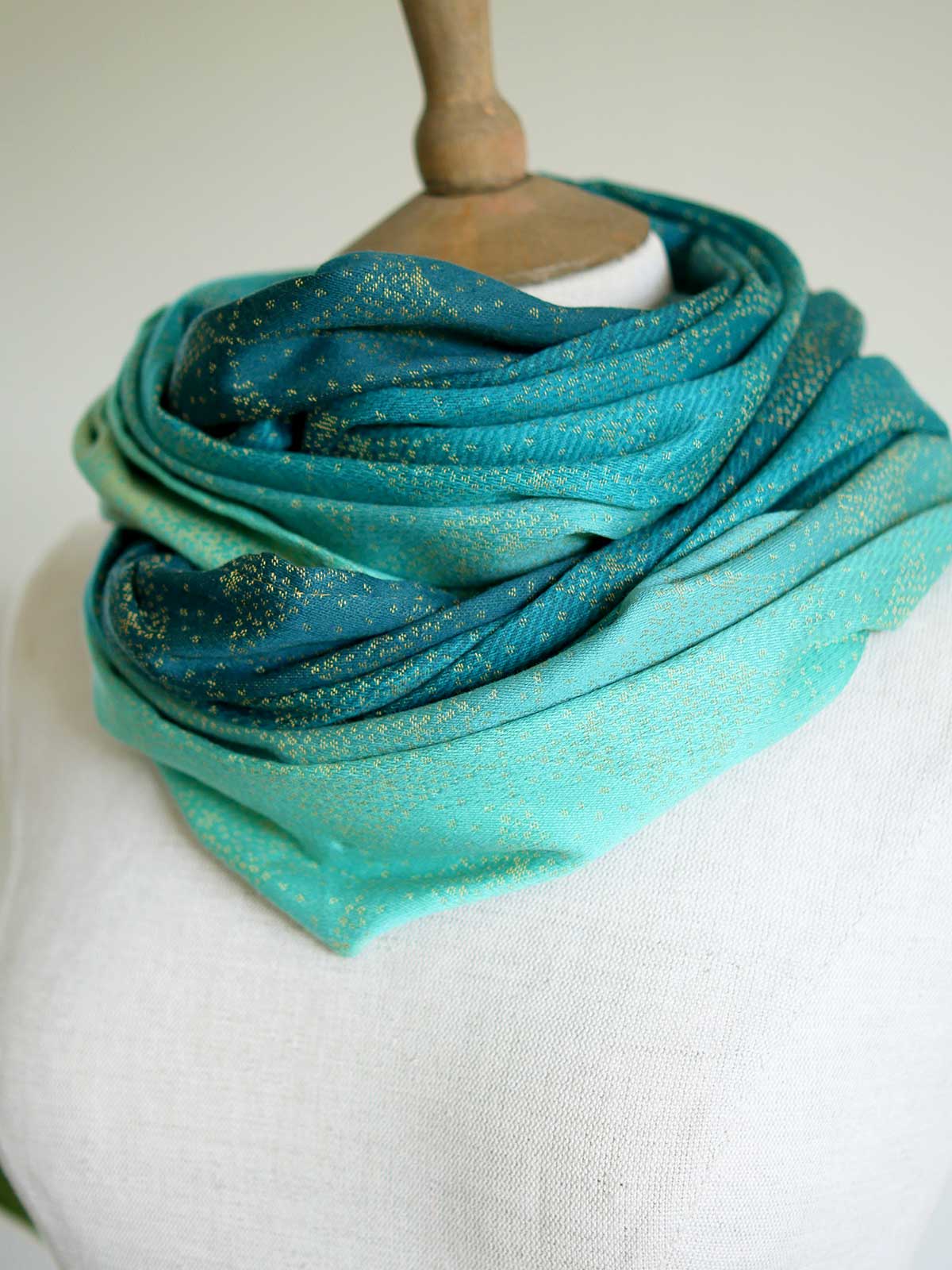 Infinity loop with teal fade and gold details double looped on mannequin