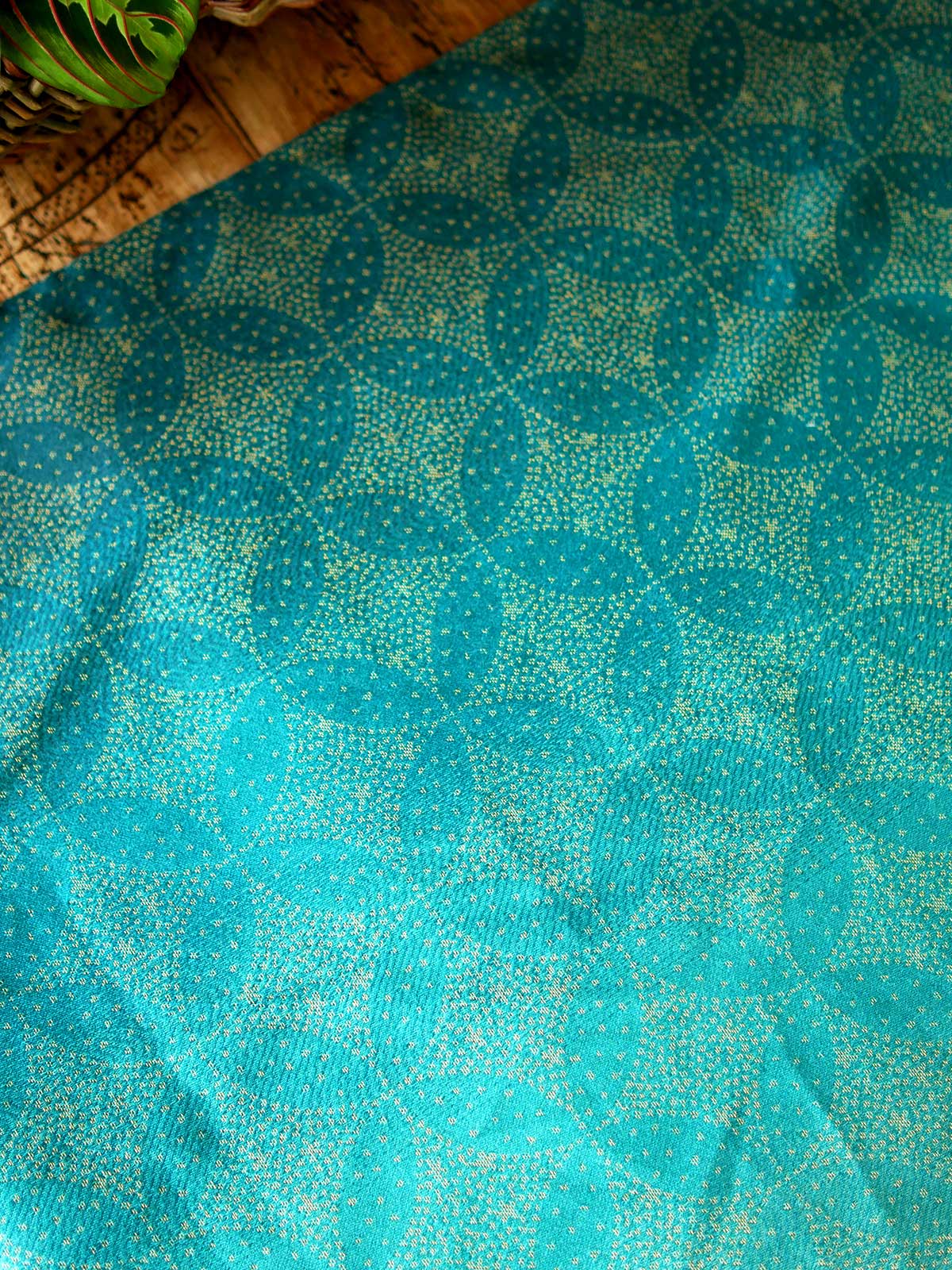 Fabric with teal fade and gold stars laid on table