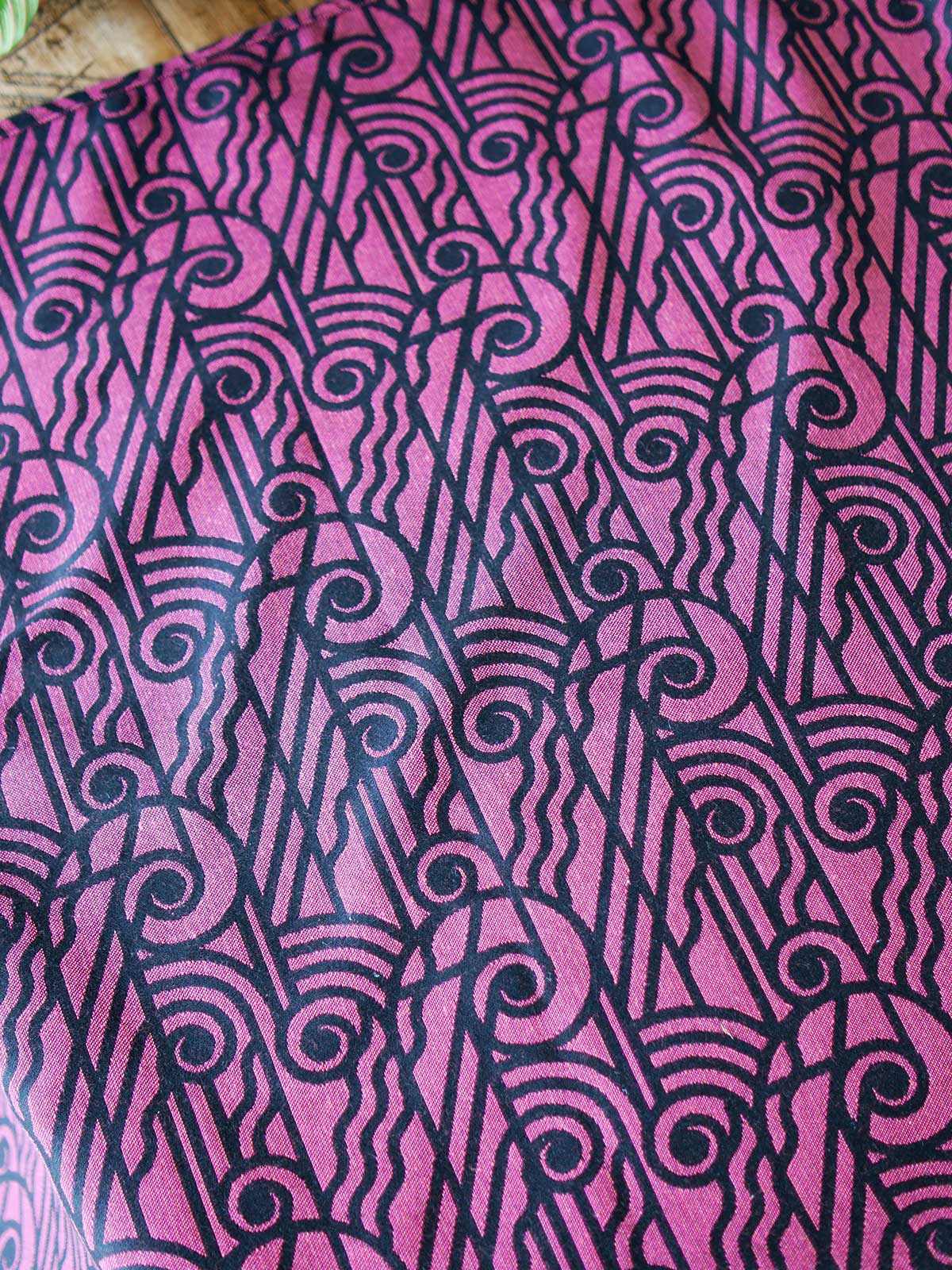 Reverse of a black wrap with pink art deco pattern