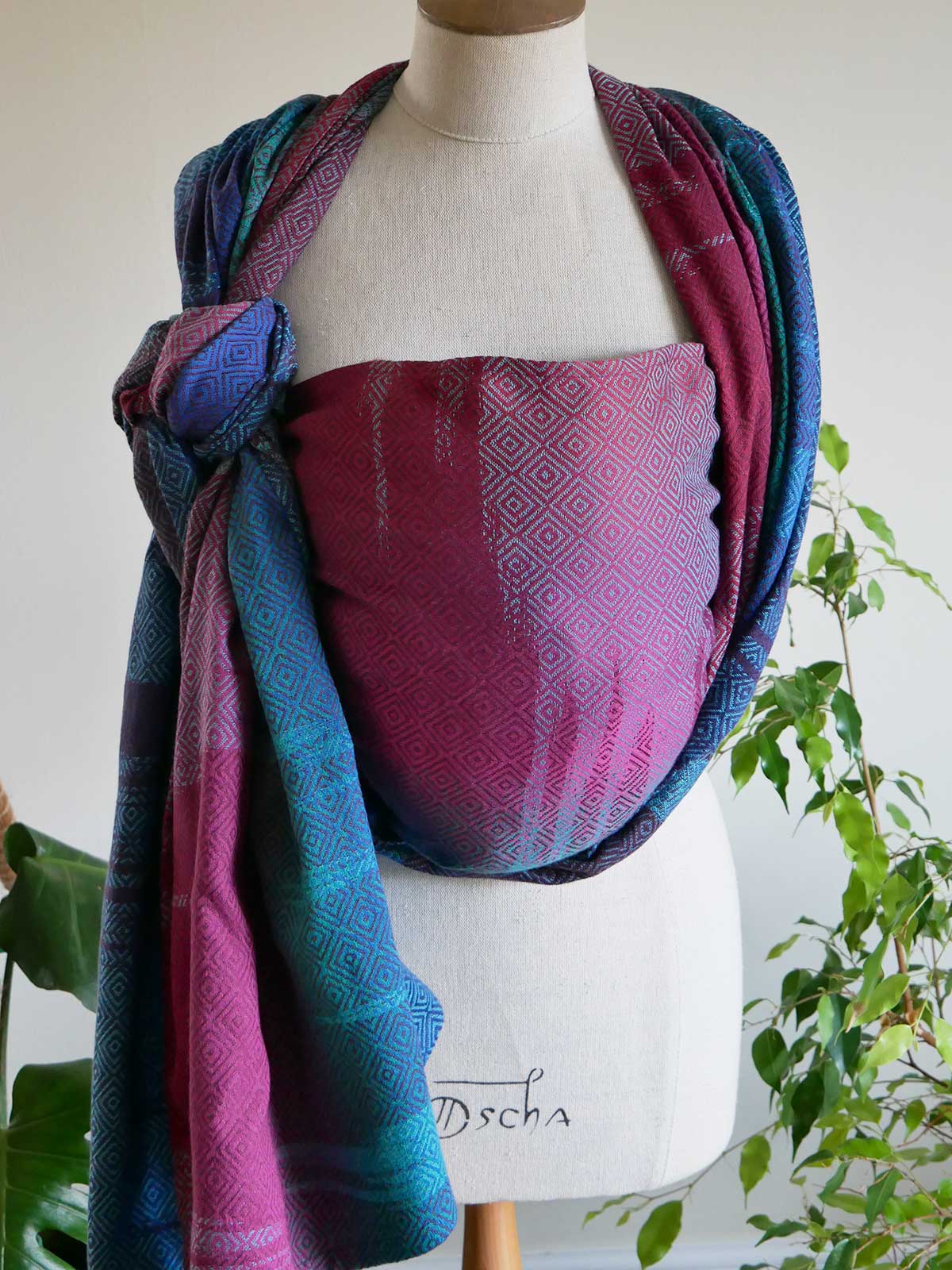 Whistle Ice Floe baby wrap on a mannequin in jewel tones