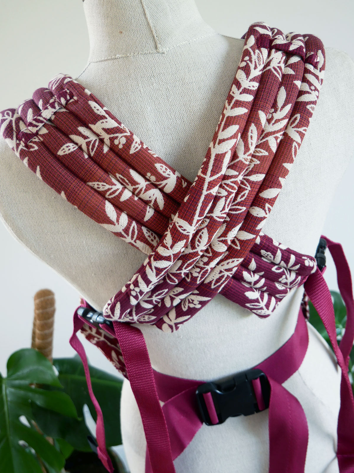Fabric straps with leaf pattern on a mannequin bust against a white background