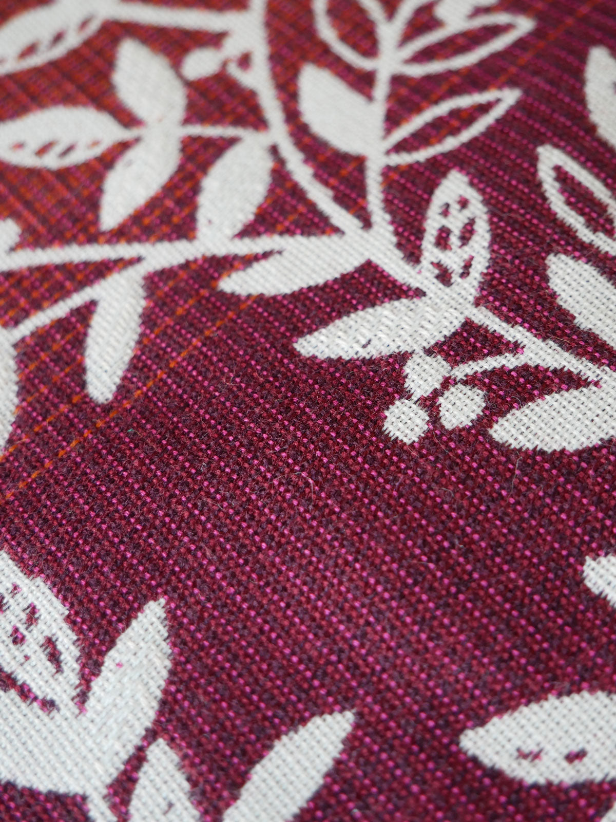 Close-up of a burgundy fabric with white floral patterns