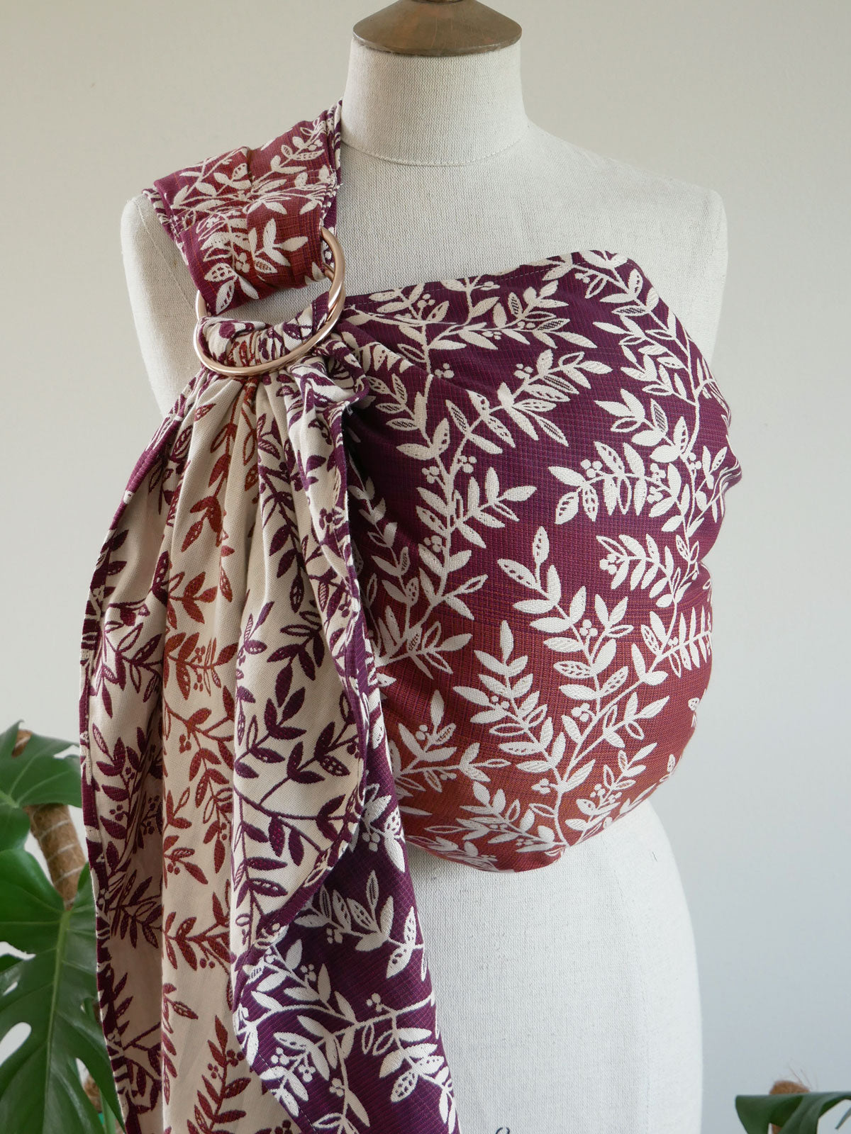 Mannequin wearing a burgundy purple and white patterned Willow Herbstlaub Ring Sling.