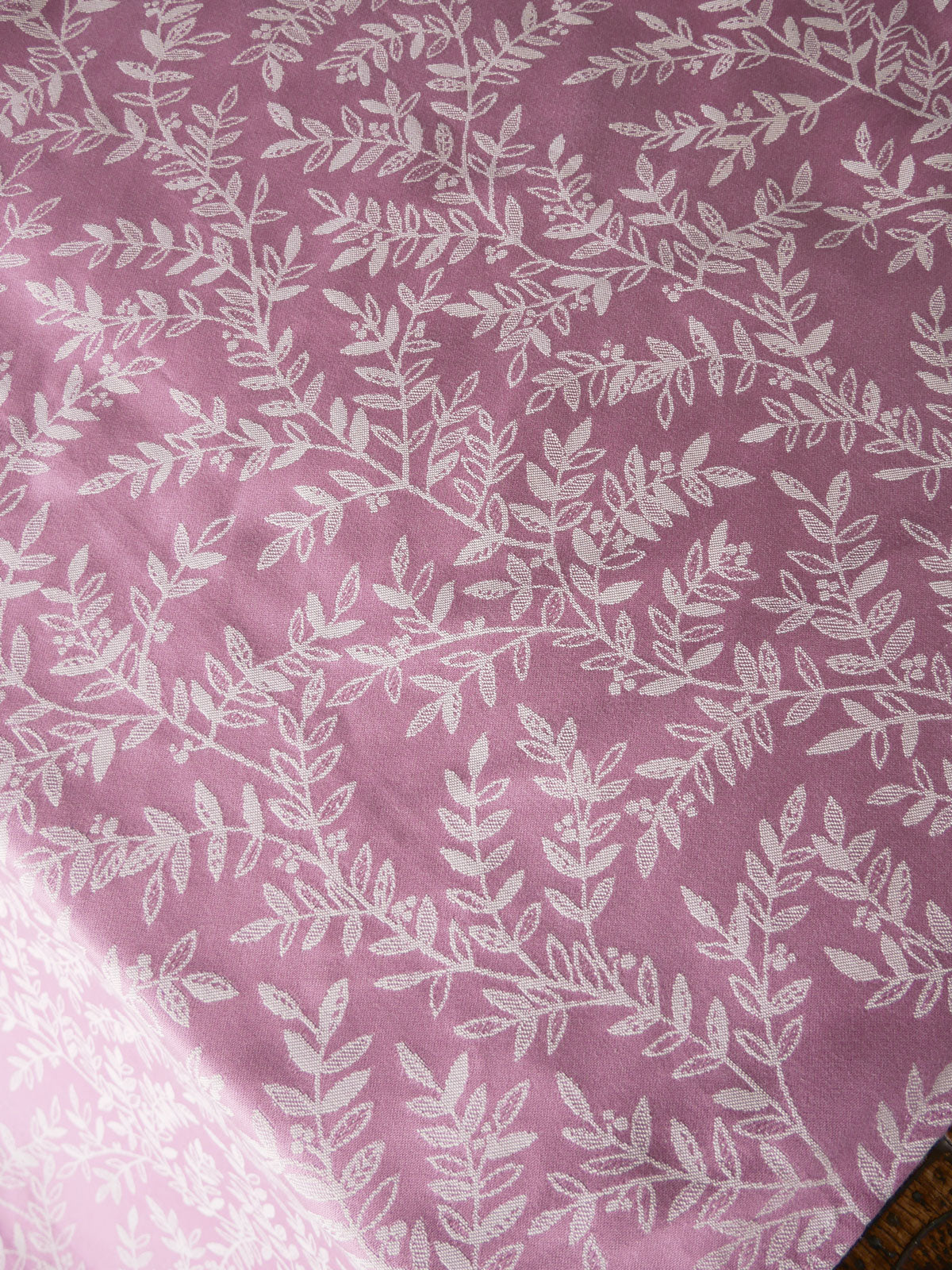 Fabric with white leaf pattern on a pink background