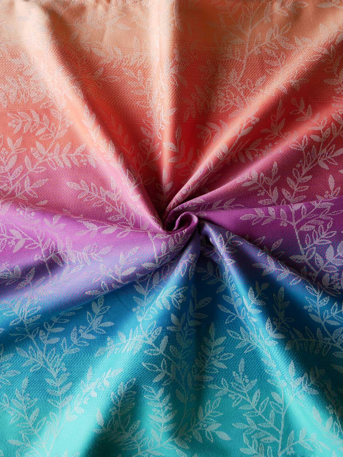 Close-up of fabric with a floral pattern in pink, purple, and blue.