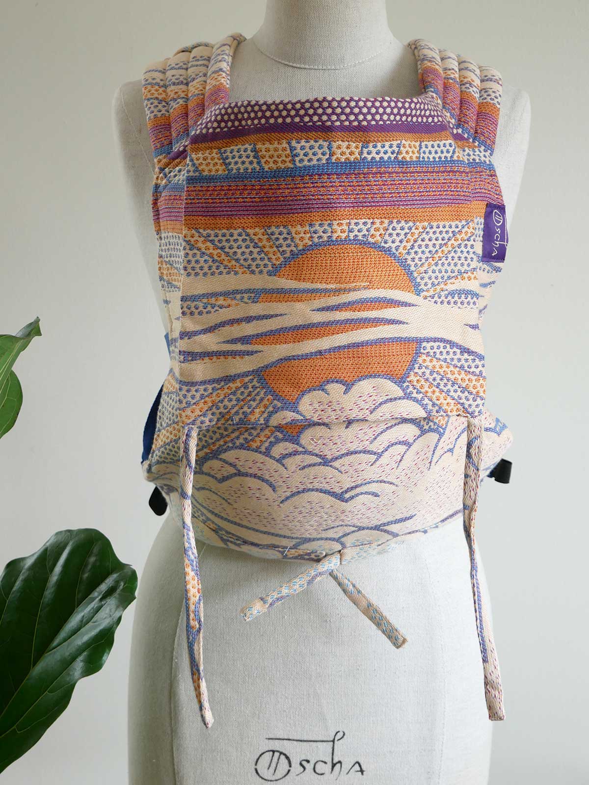 Colorful backpack with sun design on a mannequin against a white background