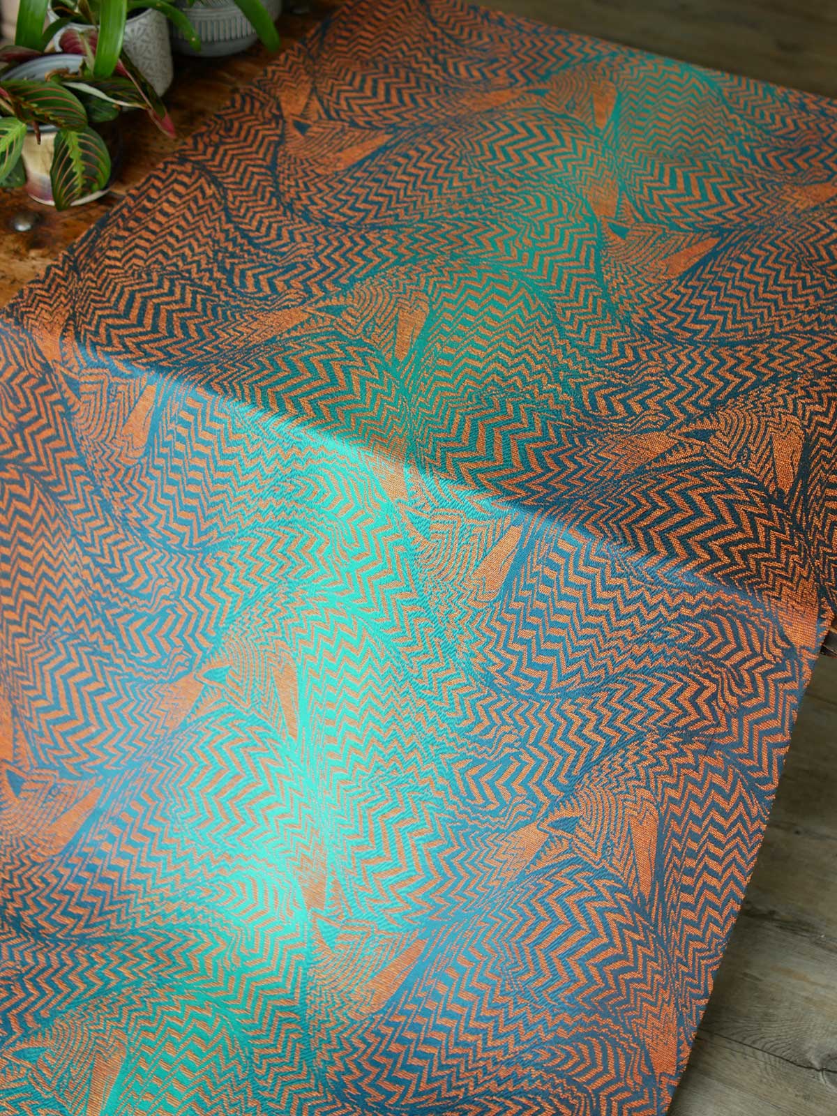 Fox pattern wrap fabric in teals and oranges.