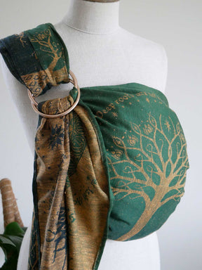 Mannequin wearing a green and gold patterned ring sling.