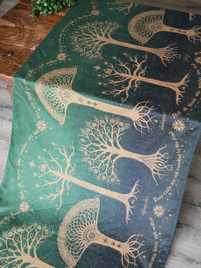 Lordof the Rings fabric with gold tree designs on a green background
