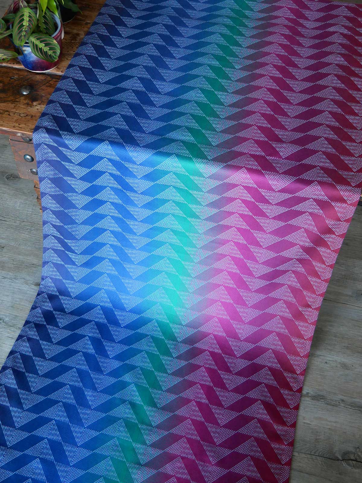 Colourful zigzag patterned fabric on a wooden surface