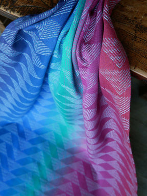 Colorful fabric with wavy pattern draped over a wooden surface