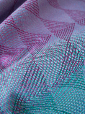 Close-up of the reverse of a fabric with pink and green pattern