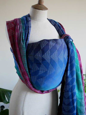Mannequin wearing a colourful woven wrap with blue geometric pattern
