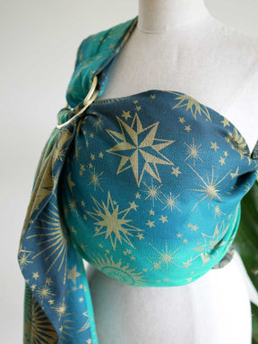 Side view of a teal ring sling with starry pattern on a mannequin