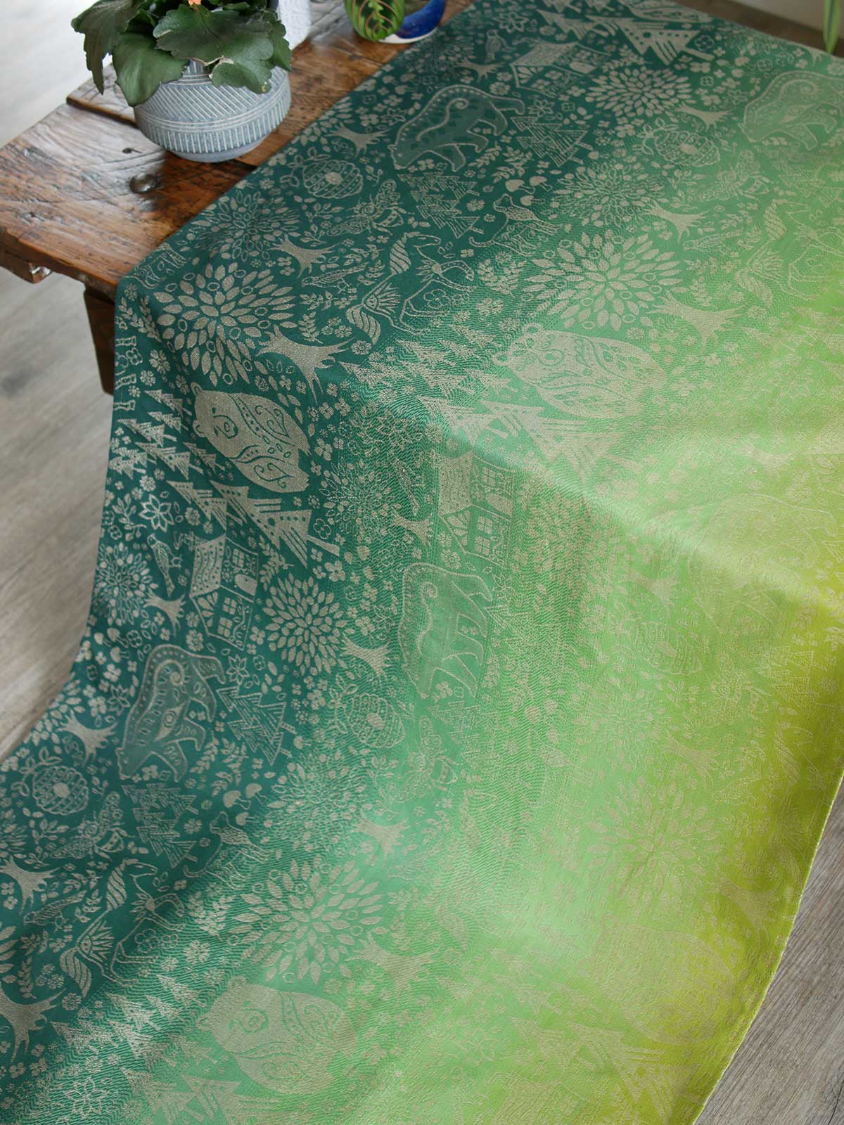 Green fabric with animal folk design.