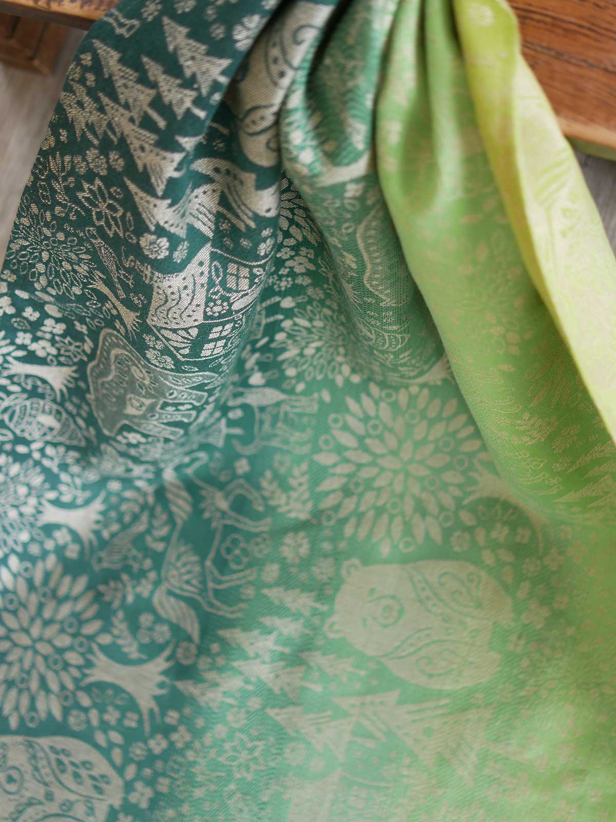 Green fabric with animal folk design.