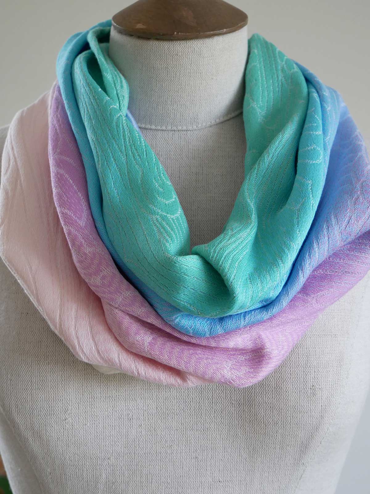Pastel-colored cowl on a mannequin against a neutral background