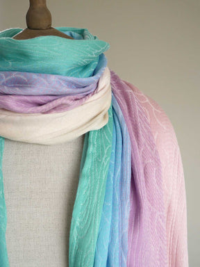 Mannequin wearing a pastel gradient scarf with teal, purple, and pink colors.