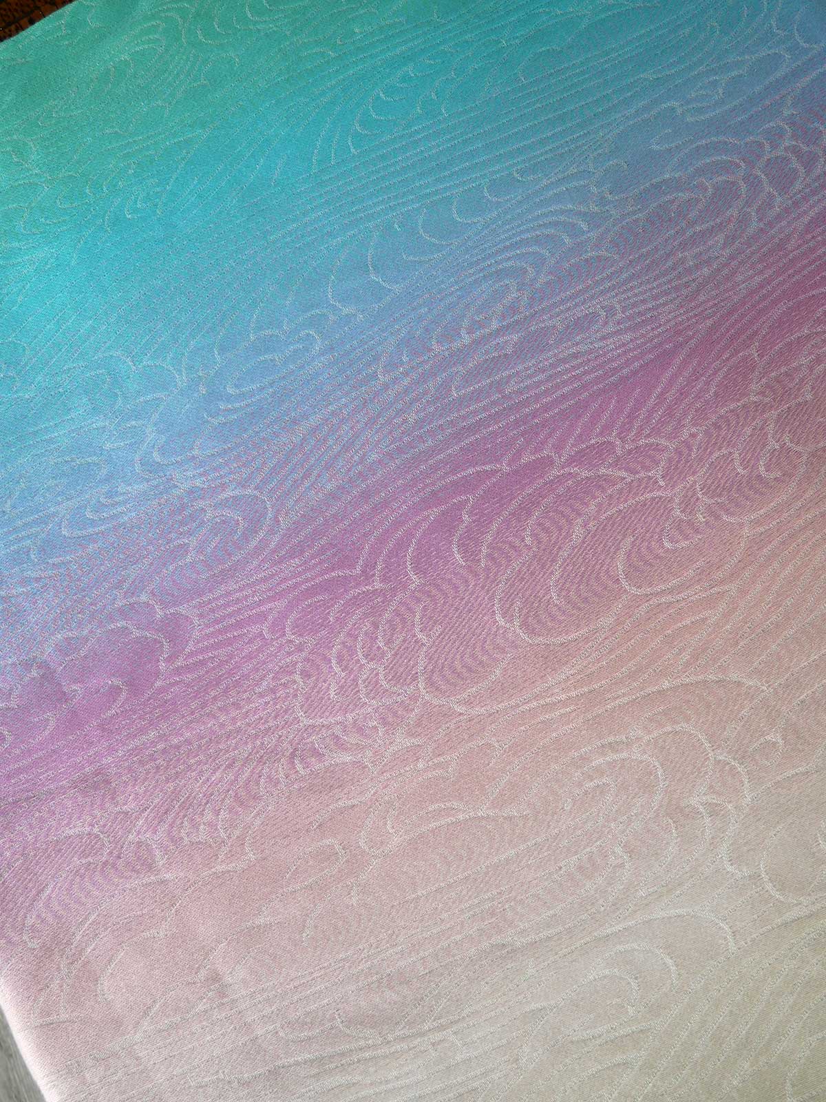 Gradient fabric with wavy pattern transitioning from blue to pink