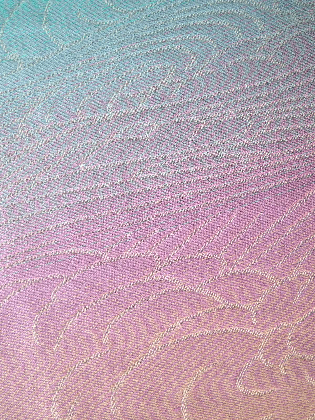 Textured fabric with a gradient pattern transitioning from blue to pink.